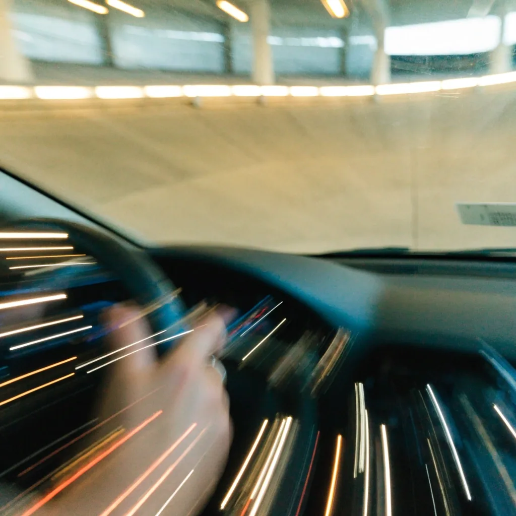 Curved down-ramp between car park levels seen from inside a descending car